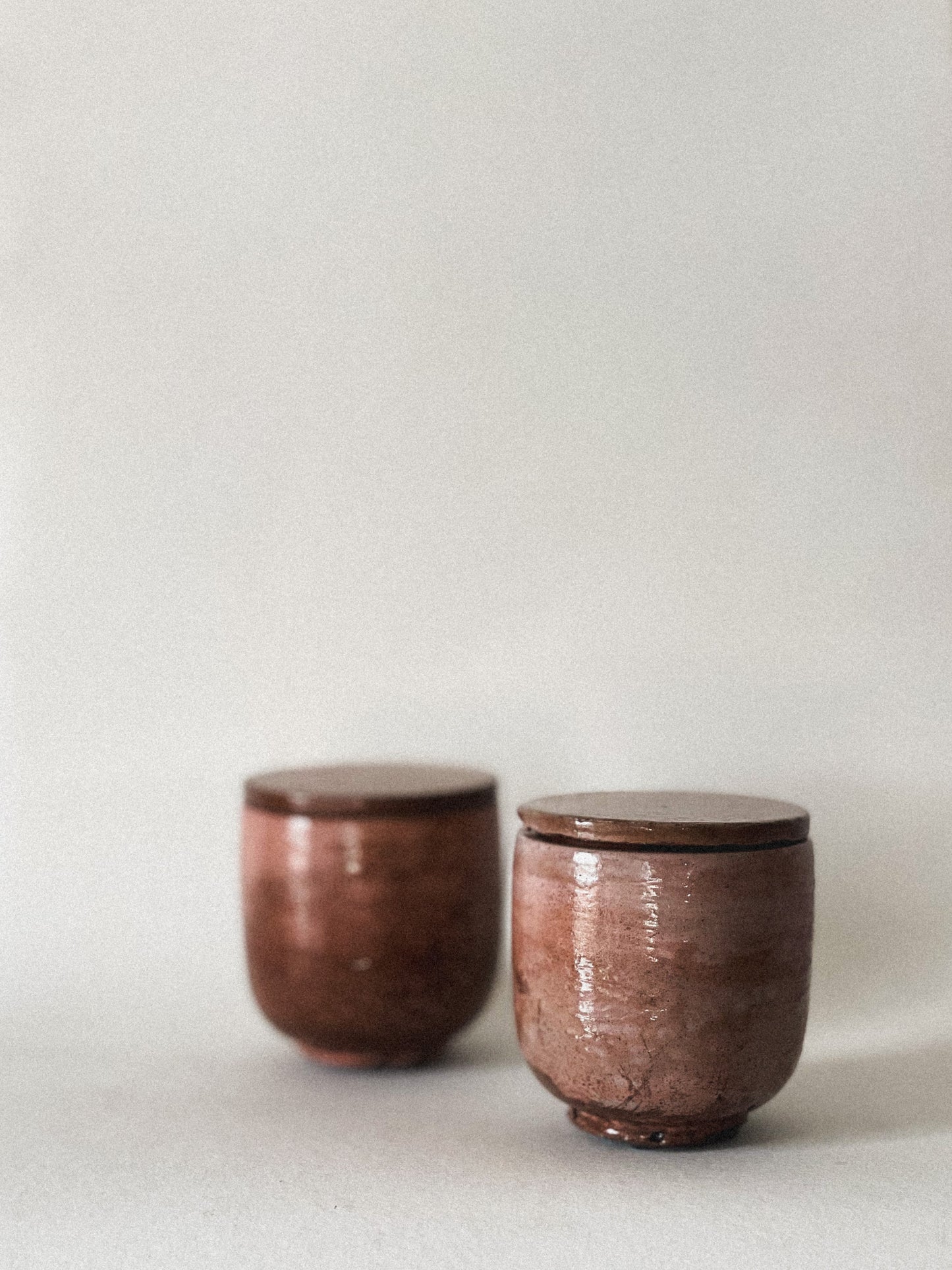 Two mini concrete candle jars on a light gray background