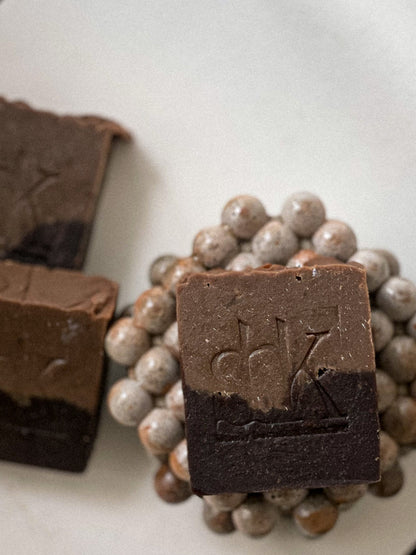 Cocoa and Goat milk soap with SBK logo on a concrete soap dish