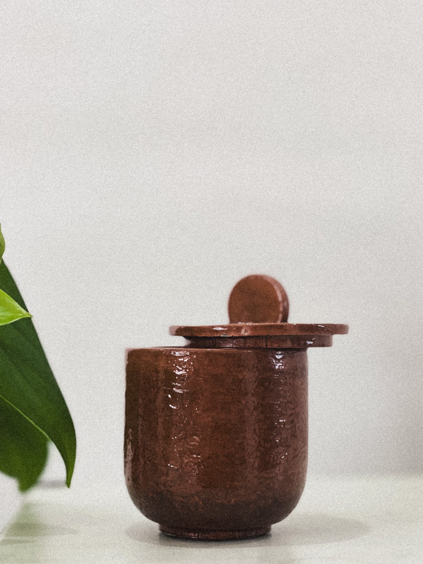 Brown concrete candle jar with lid on a light gray background